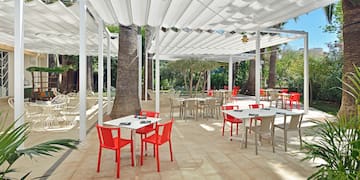 a white covered patio with tables and chairs