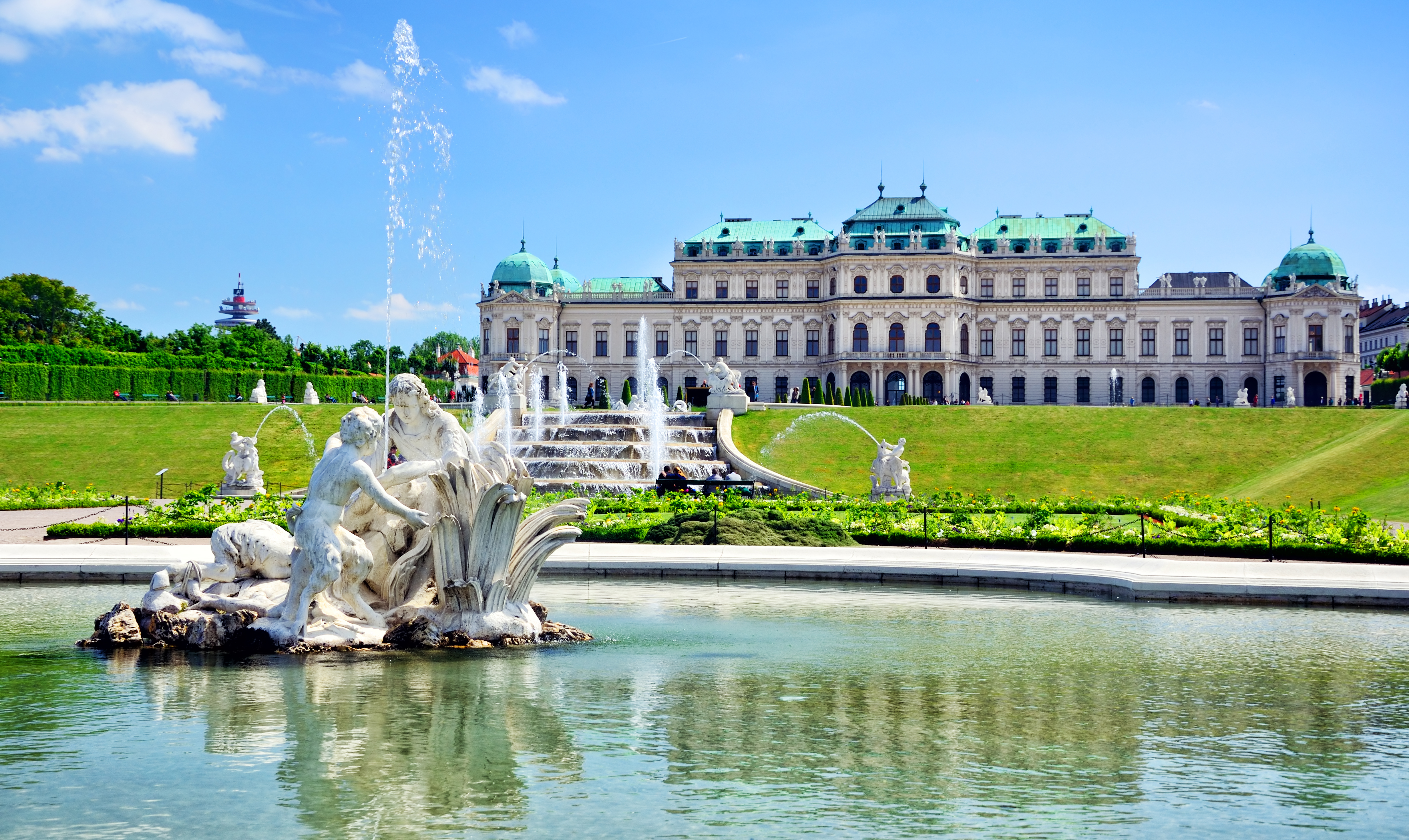 a fountain in front of a large building with Belvedere, Vienna in the background