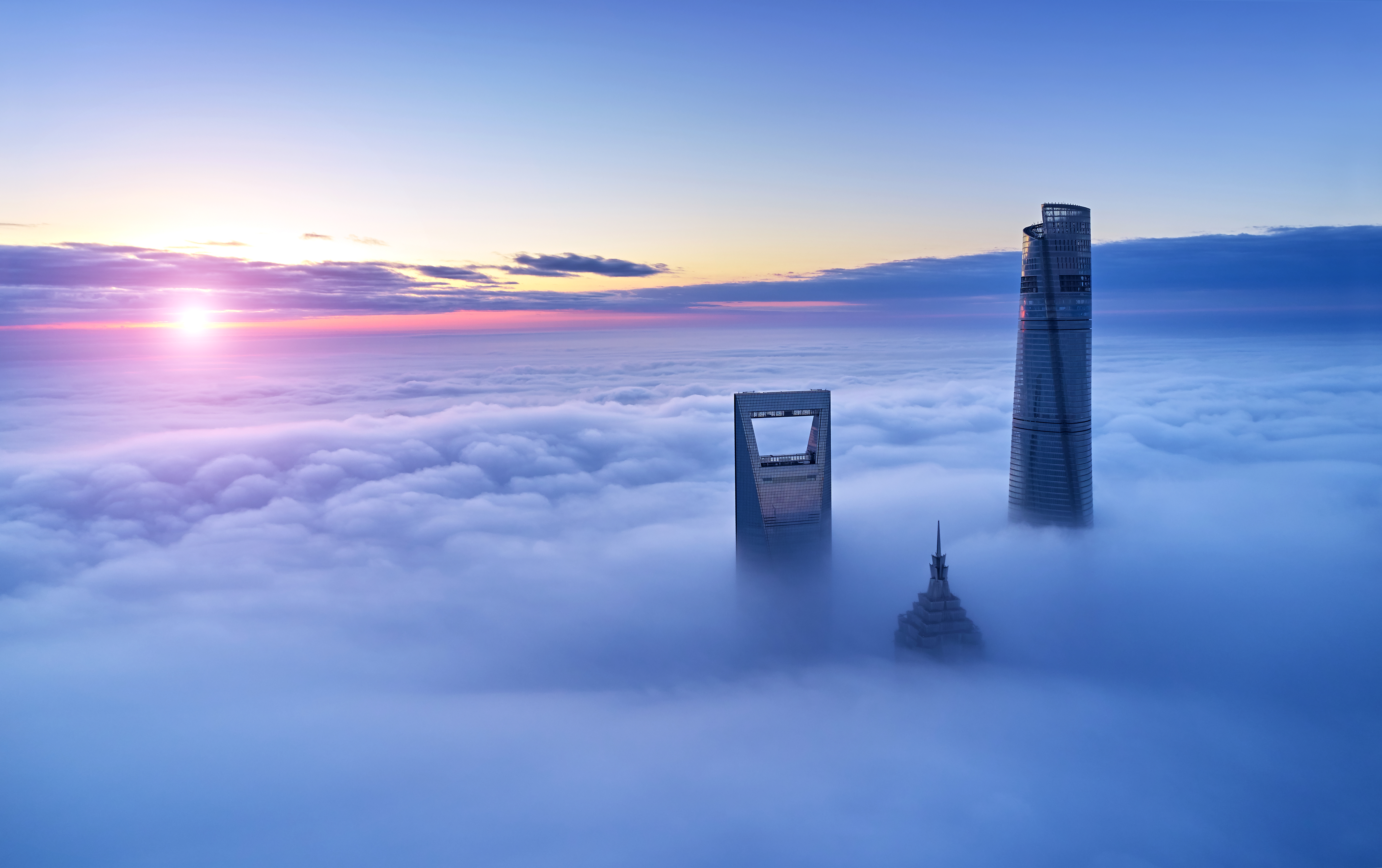 a group of tall buildings in the clouds