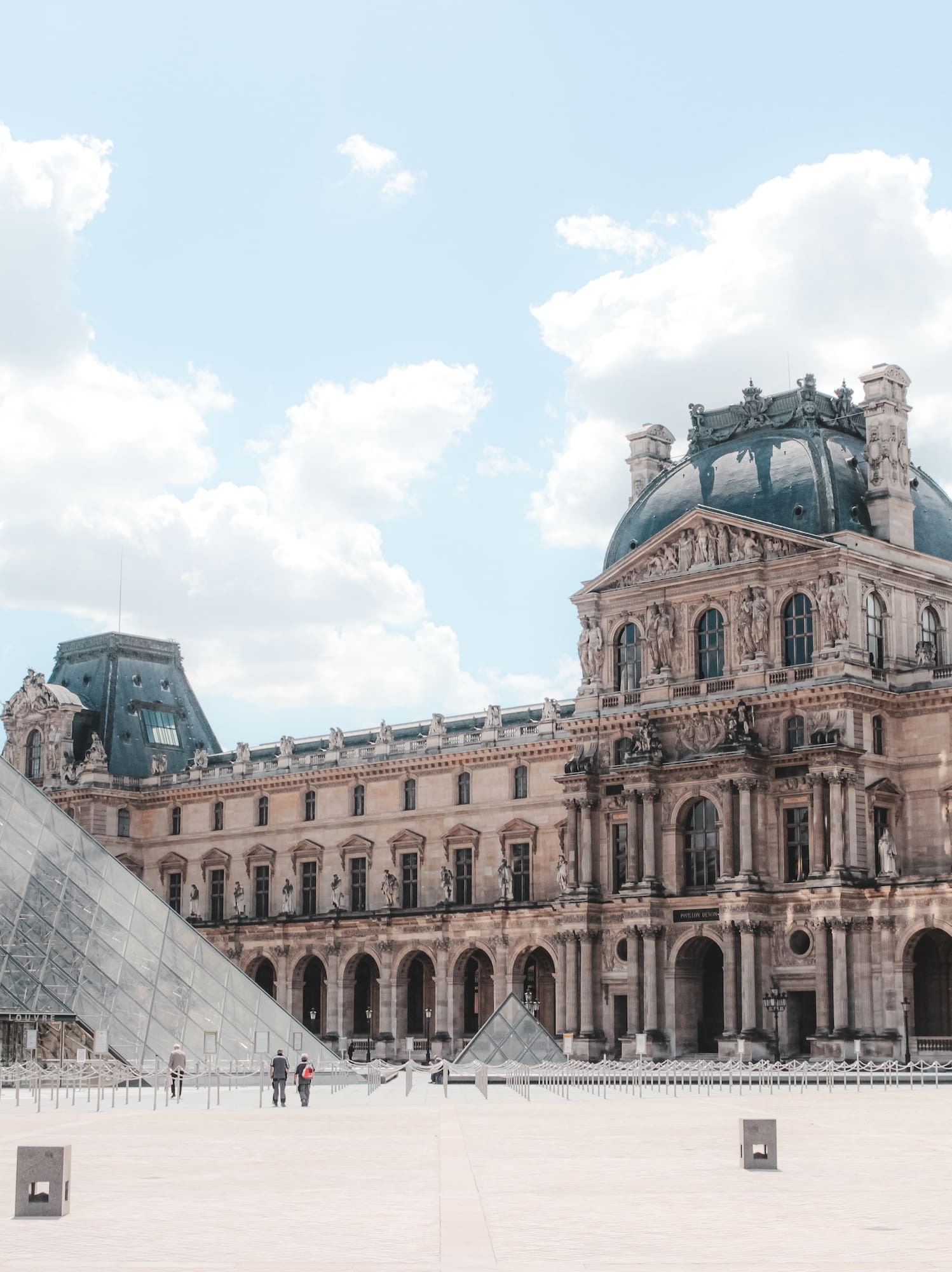 a large building with a glass pyramid