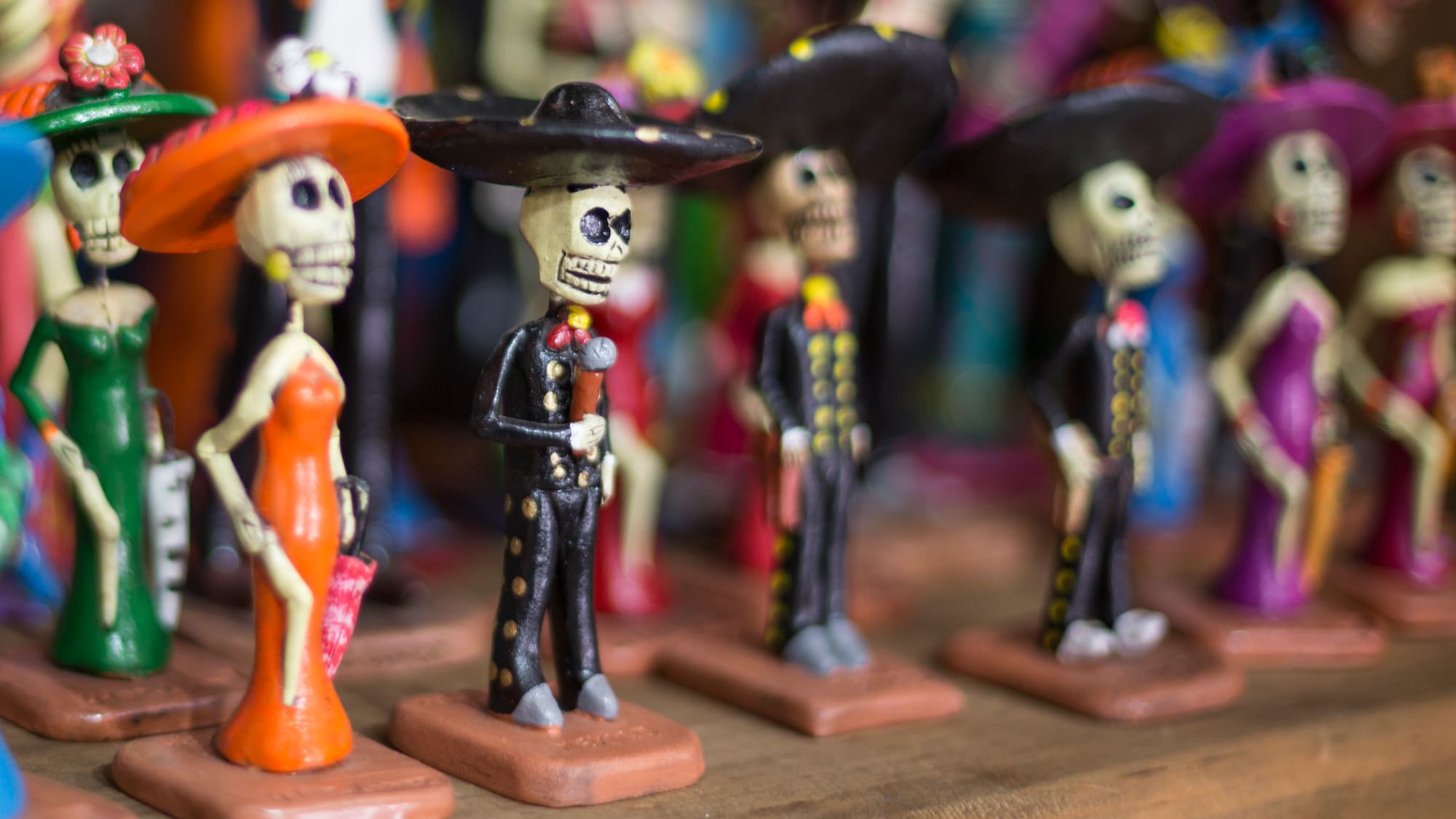 a group of small figurines of skeletons