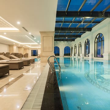 a indoor pool with chairs and a ceiling