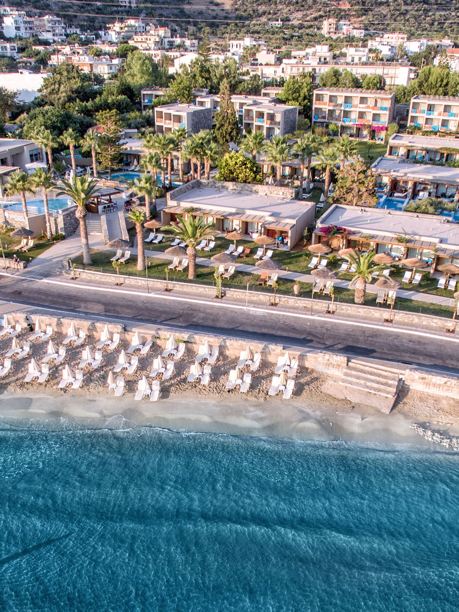a beach with a body of water and buildings
