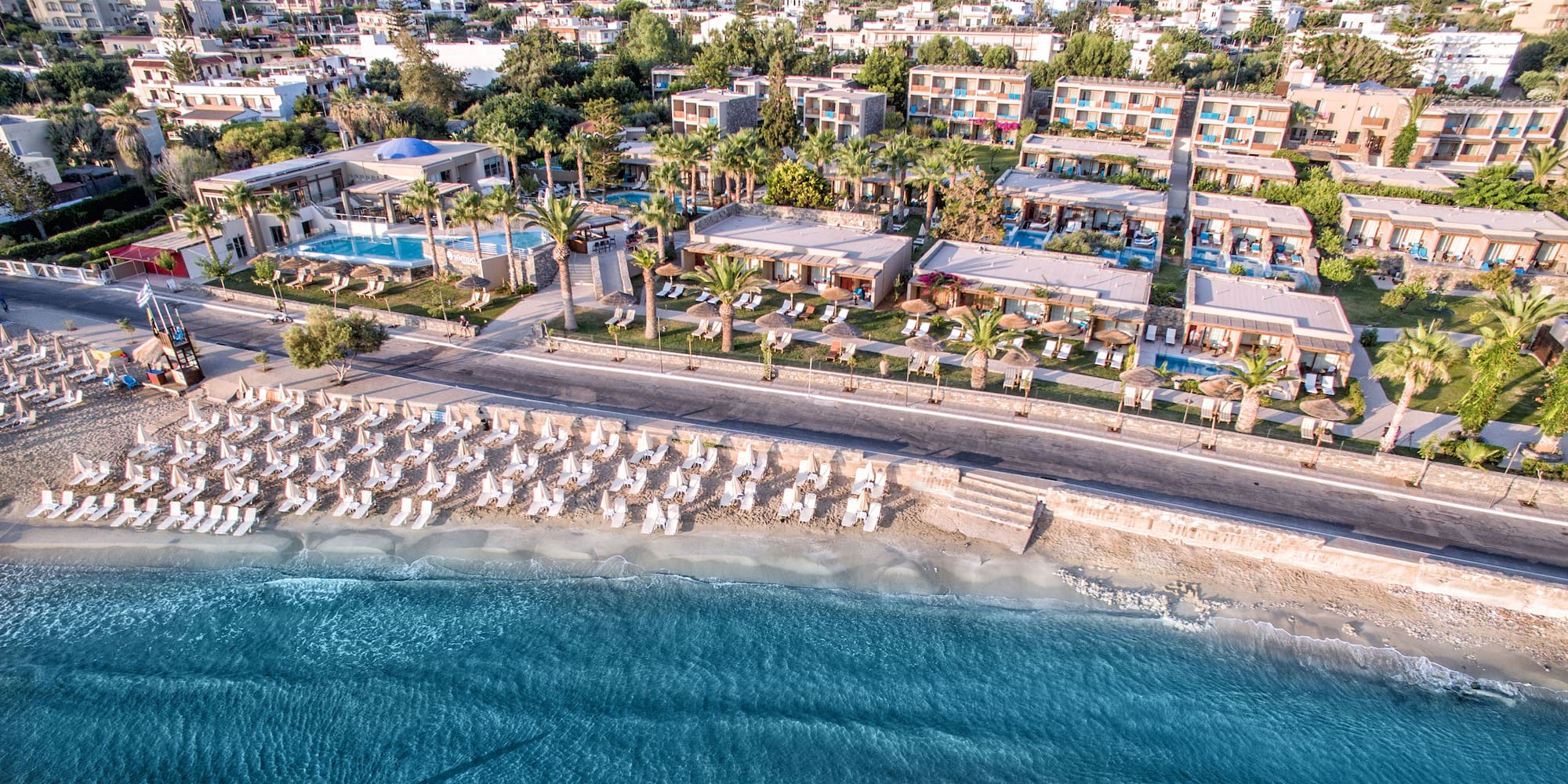 a beach with a body of water and buildings
