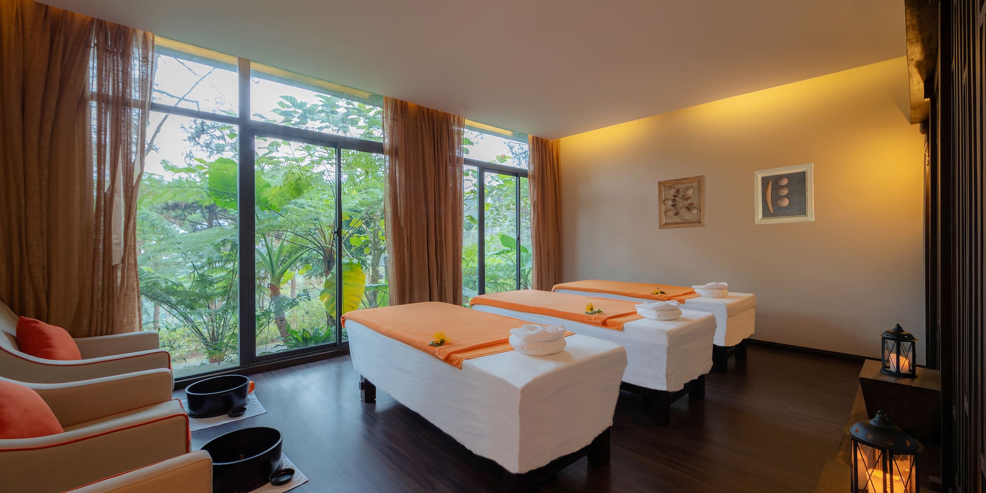 a room with beds and chairs