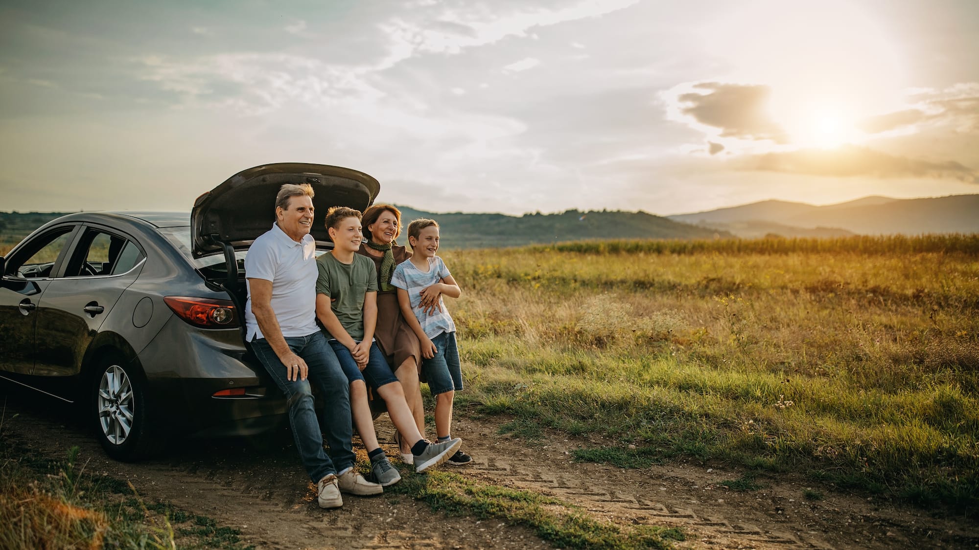 a group of people sitting on the back of a car