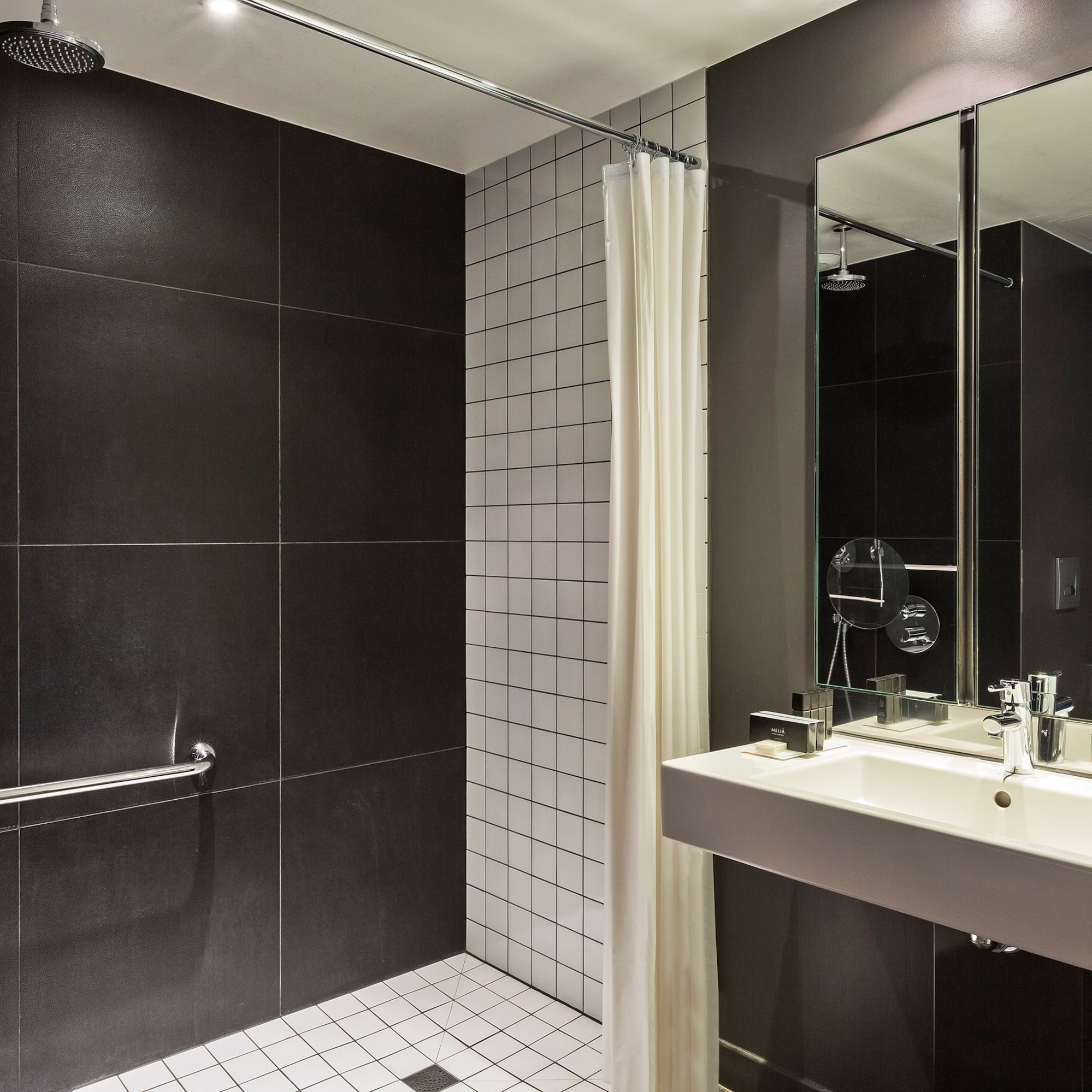 a bathroom with a shower and sink