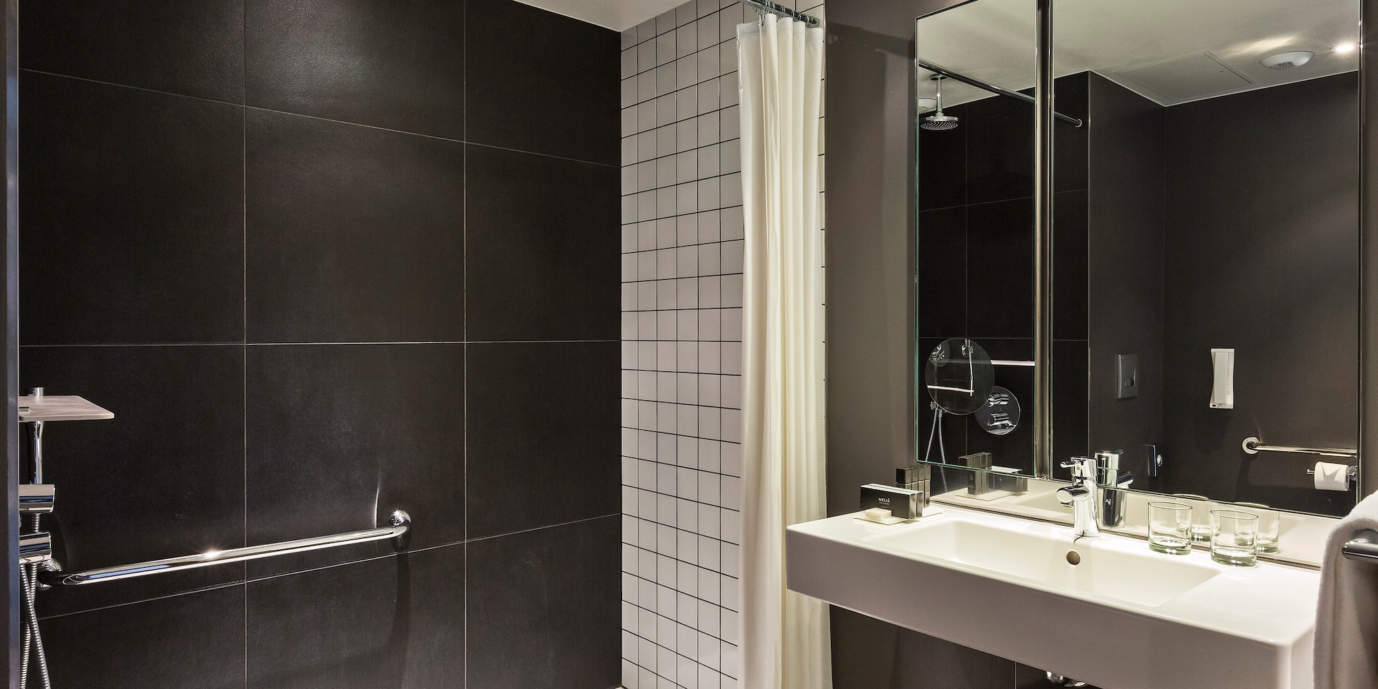 a bathroom with a shower and sink