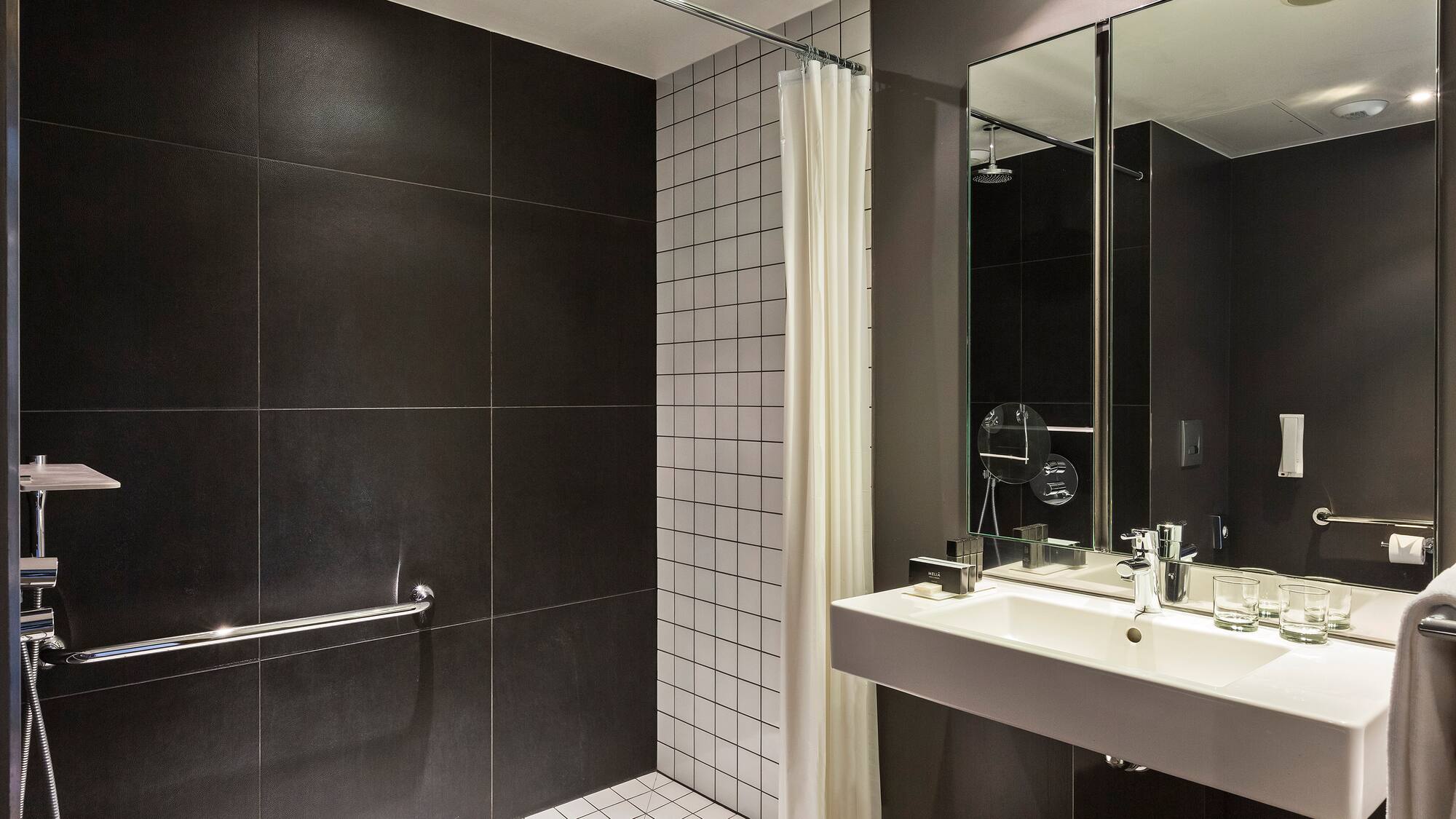 a bathroom with a shower and sink