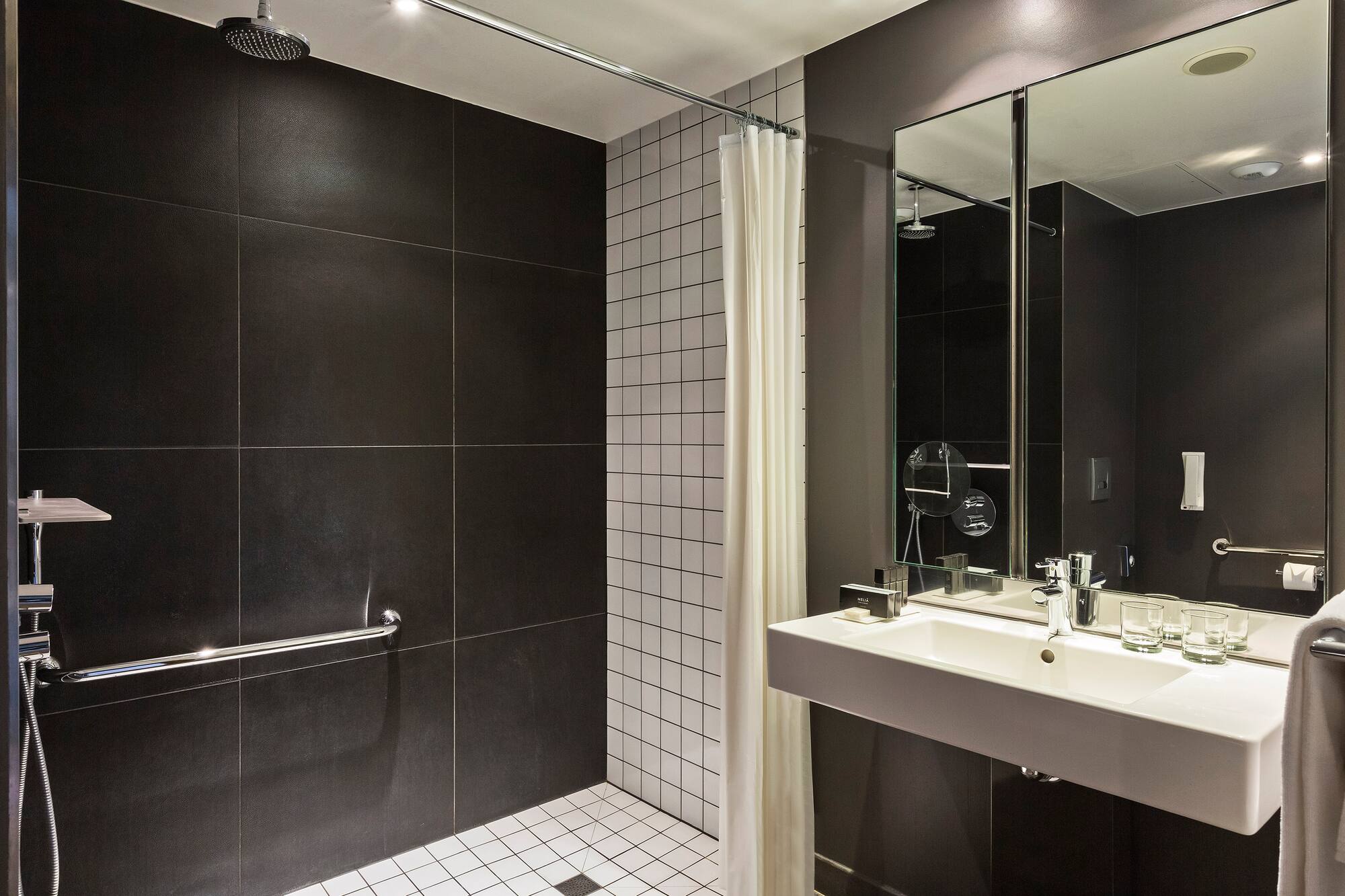 a bathroom with a shower and sink