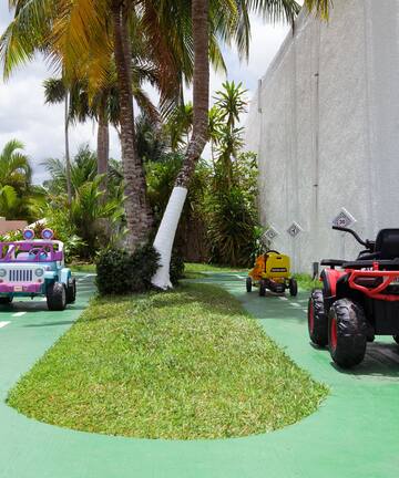 a group of toy cars on a green road