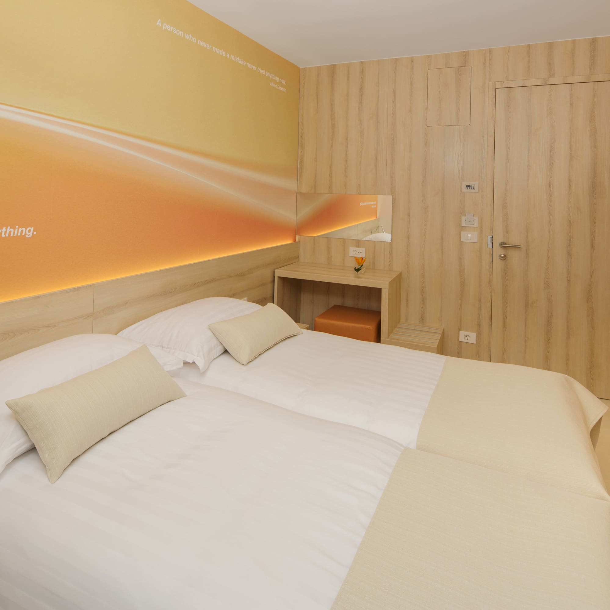 a room with two beds and a door