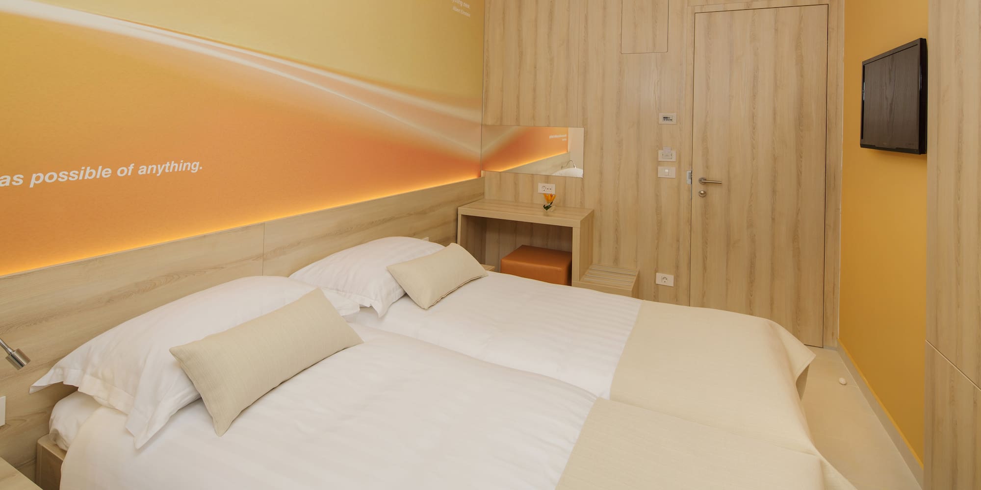 a room with two beds and a door