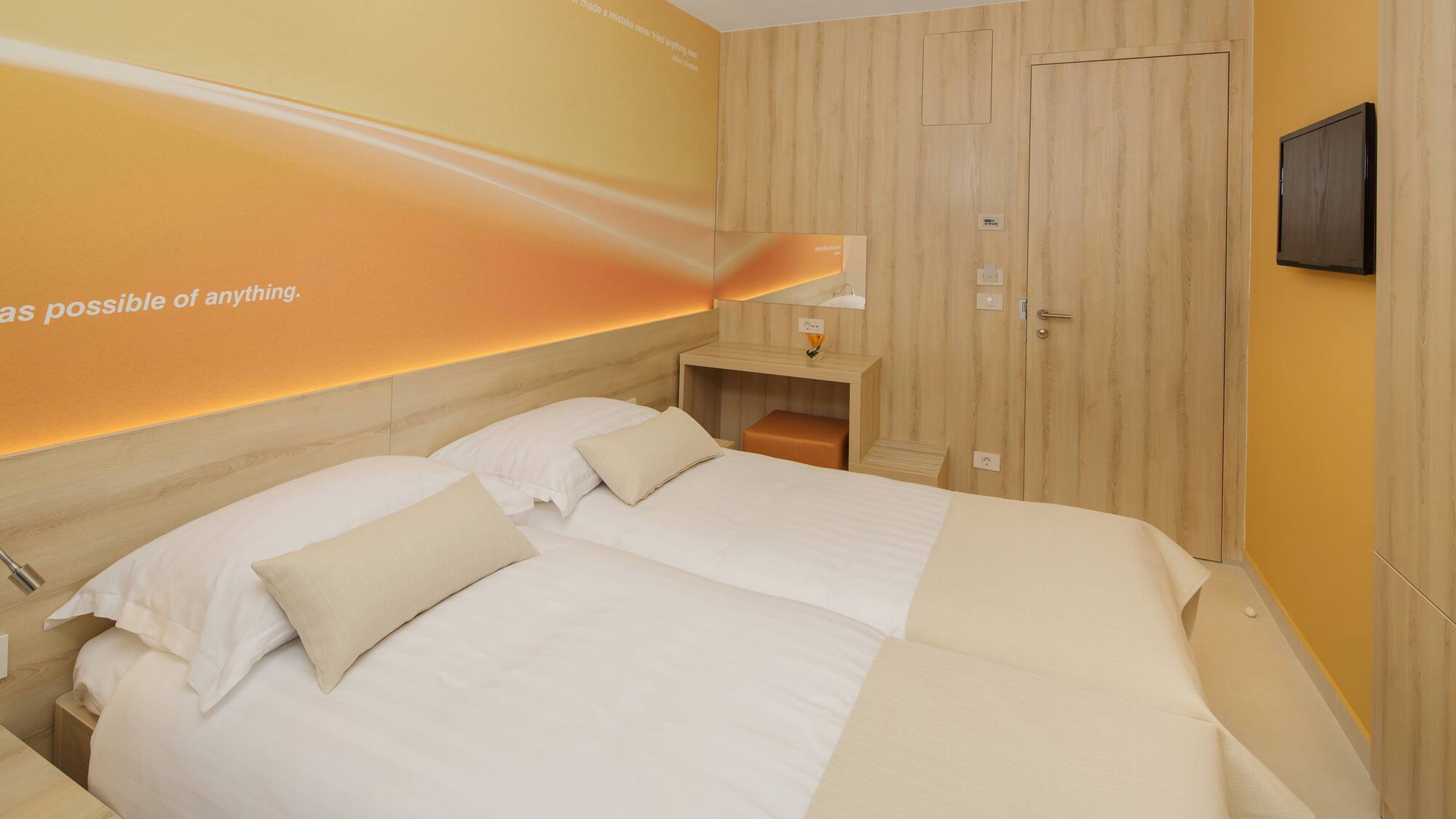 a room with two beds and a door