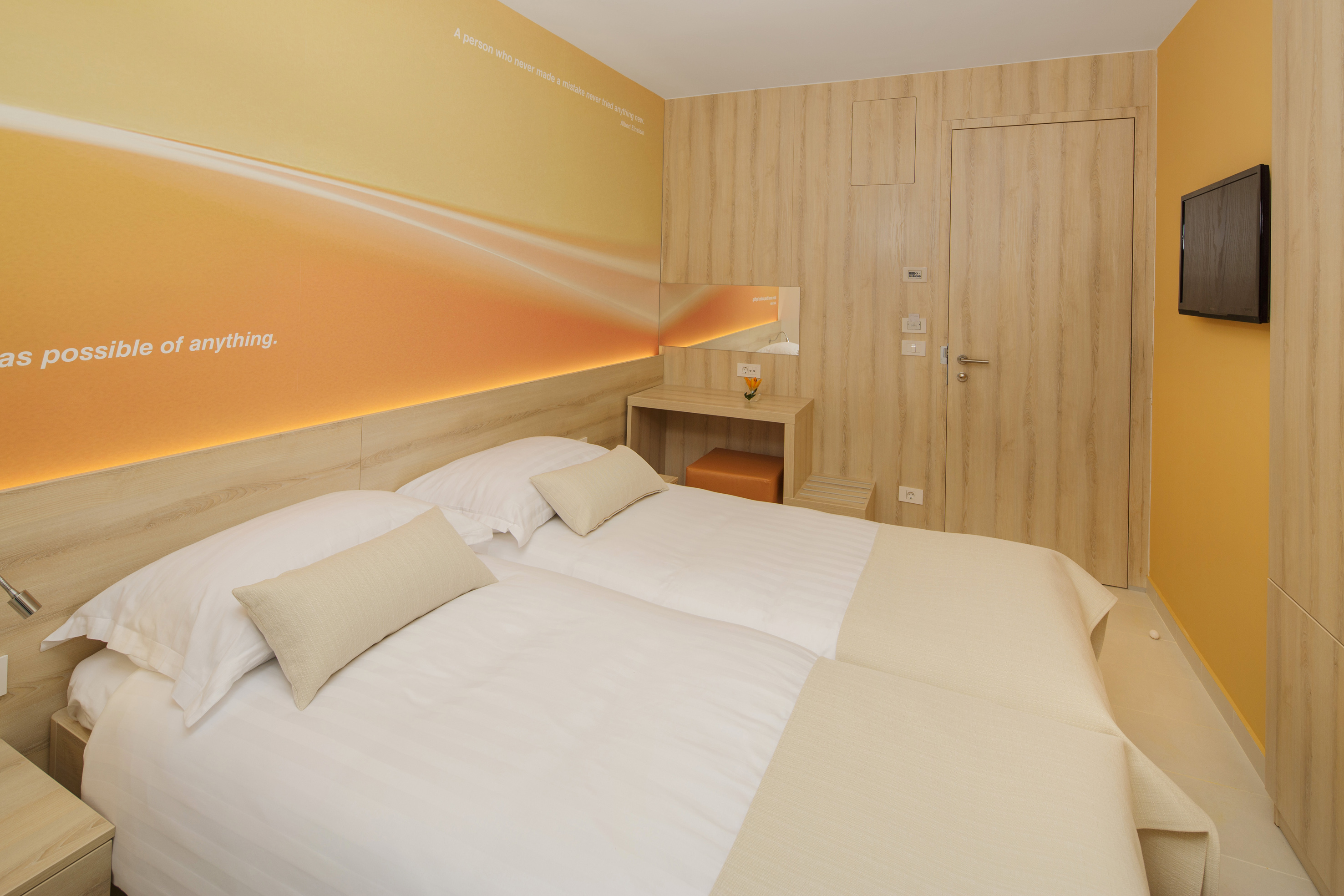 a room with two beds and a door
