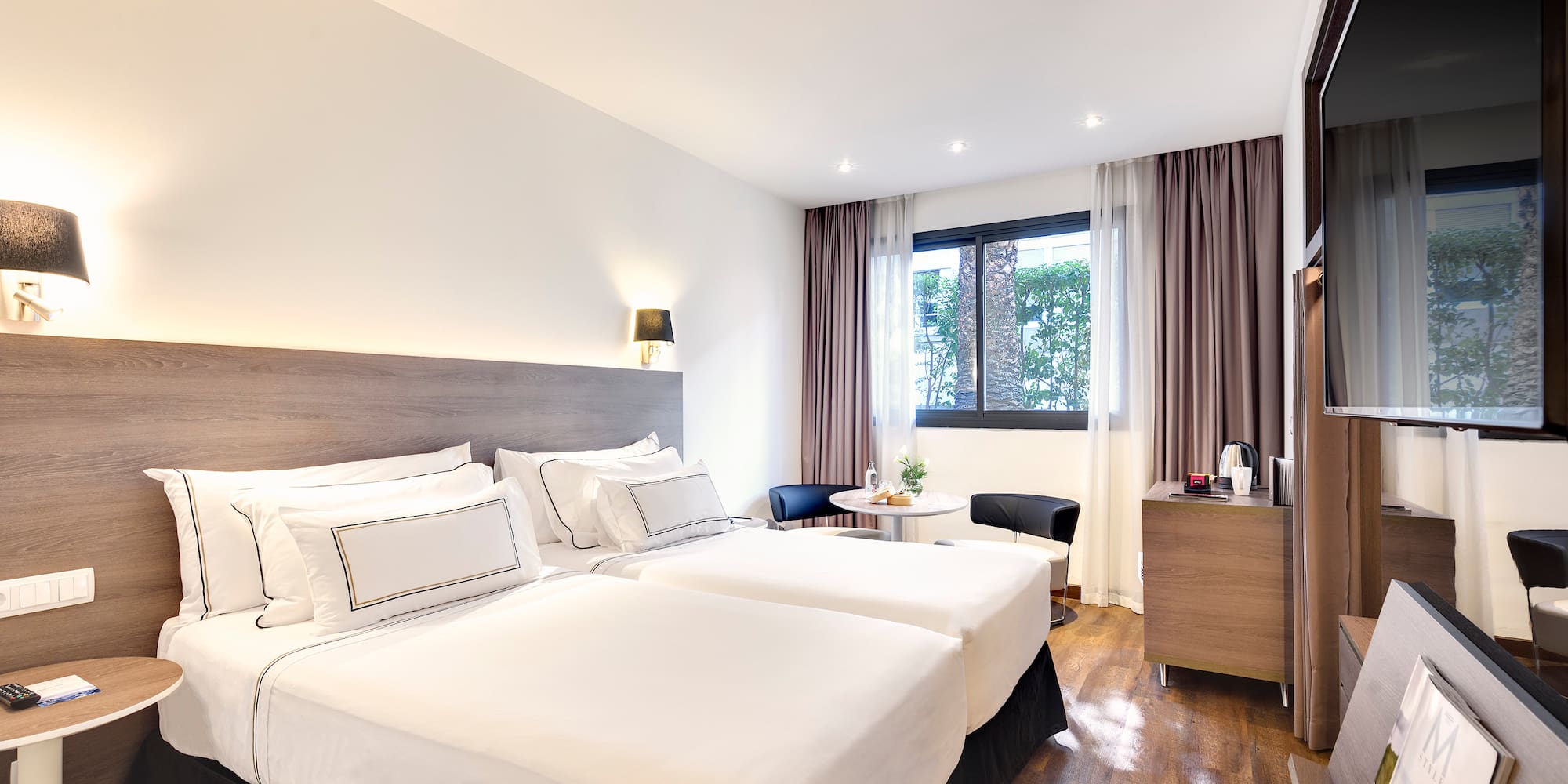 a room with two beds and a table