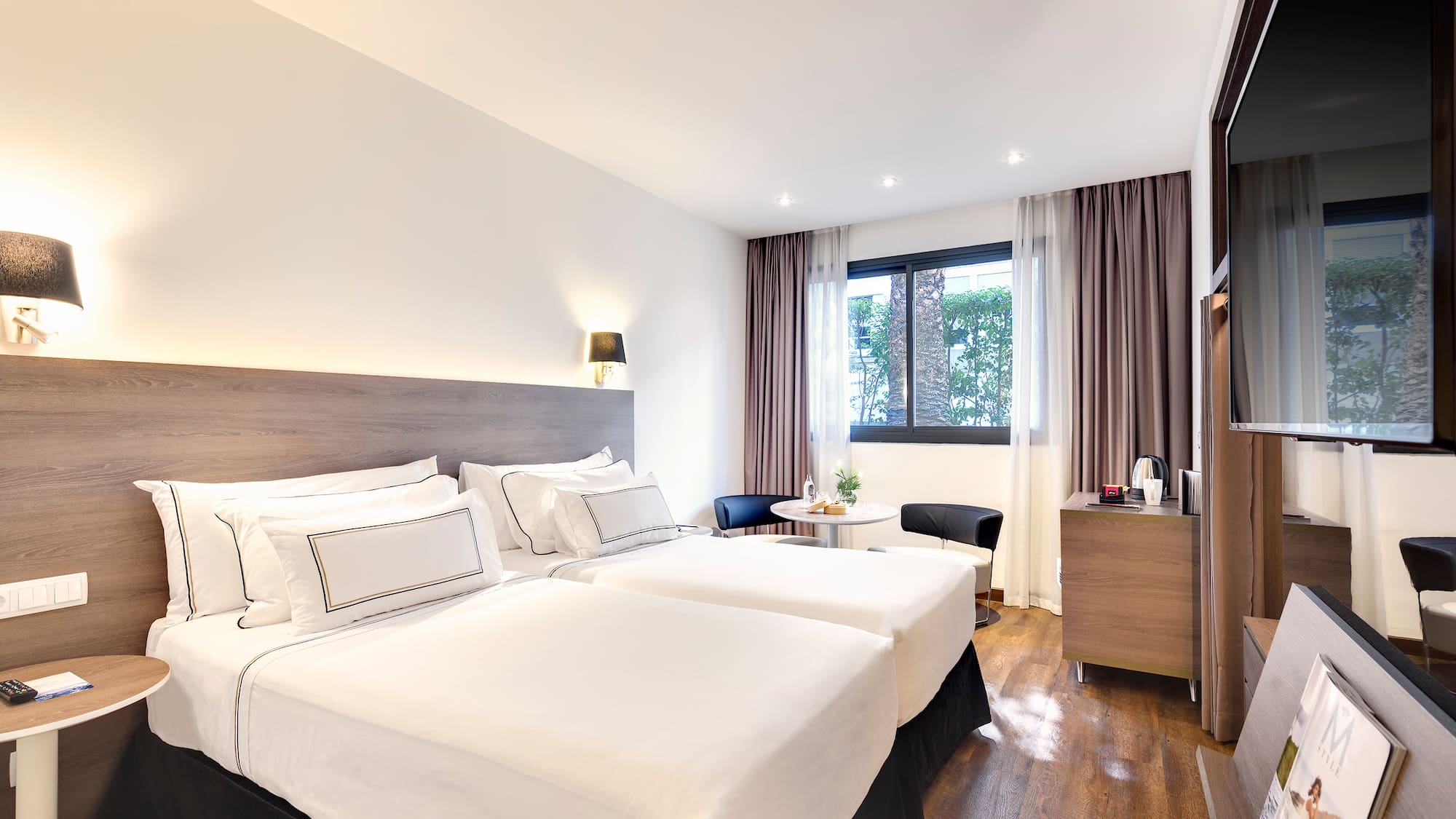 a room with two beds and a table