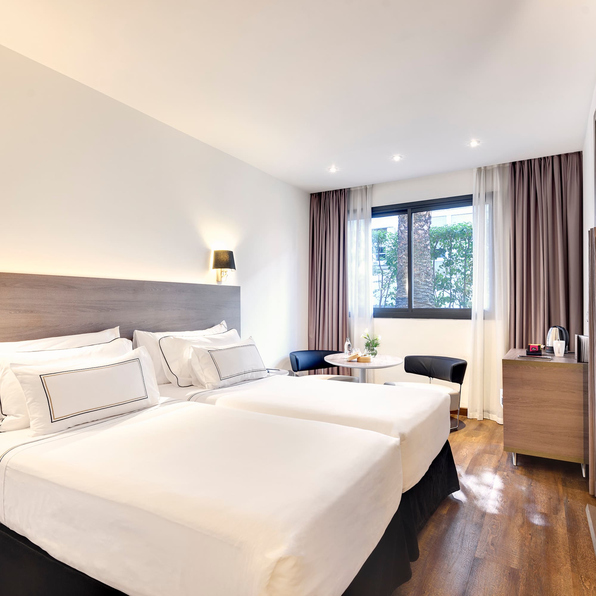 a room with two beds and a table