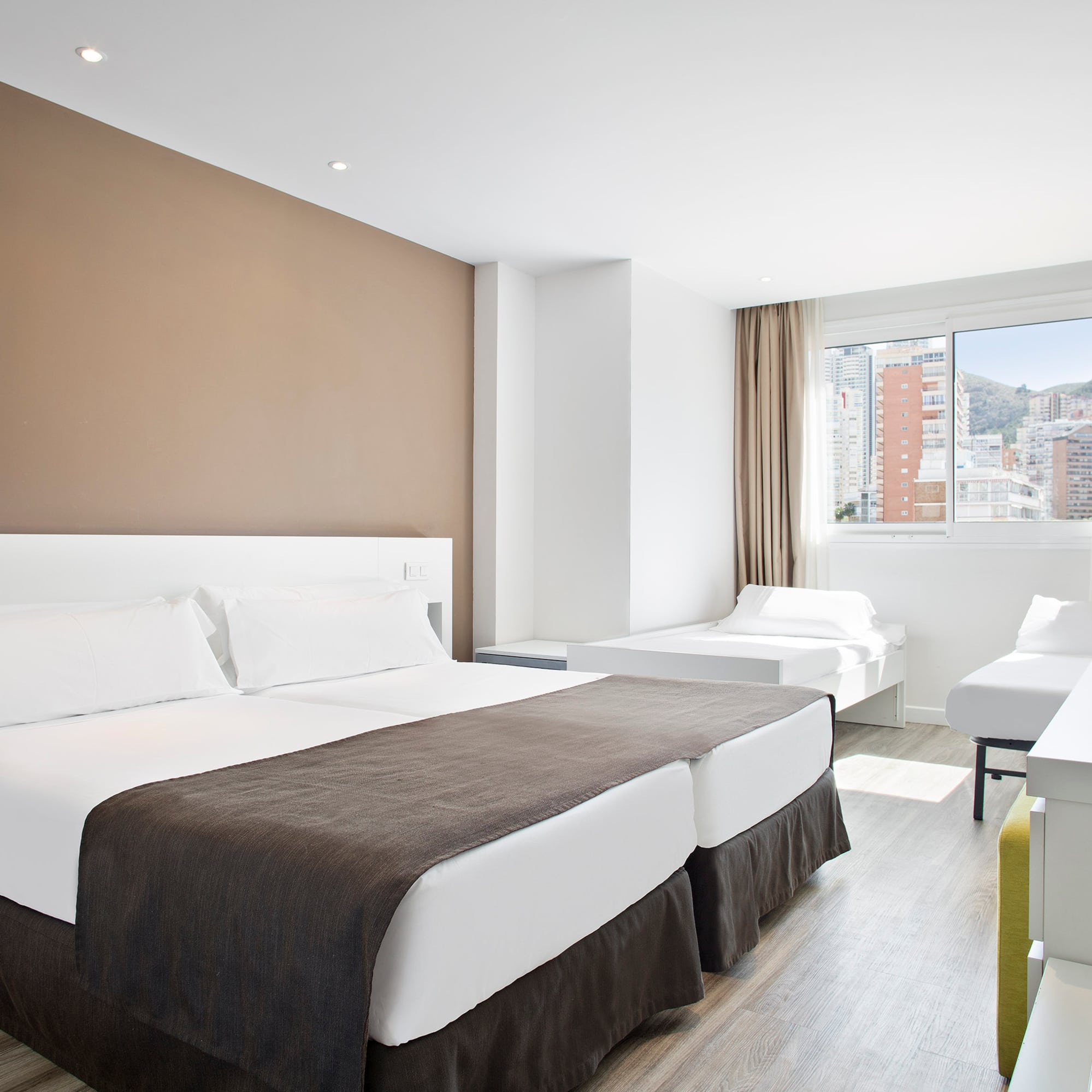 a room with two beds and a window