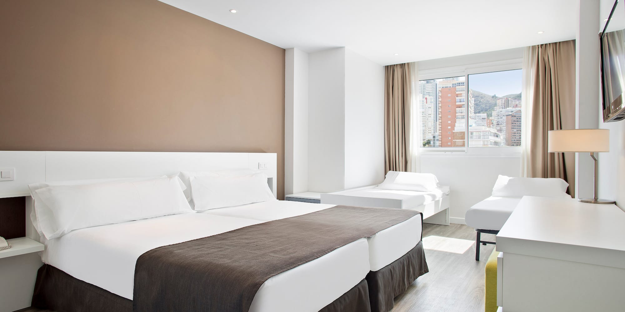 a room with two beds and a window