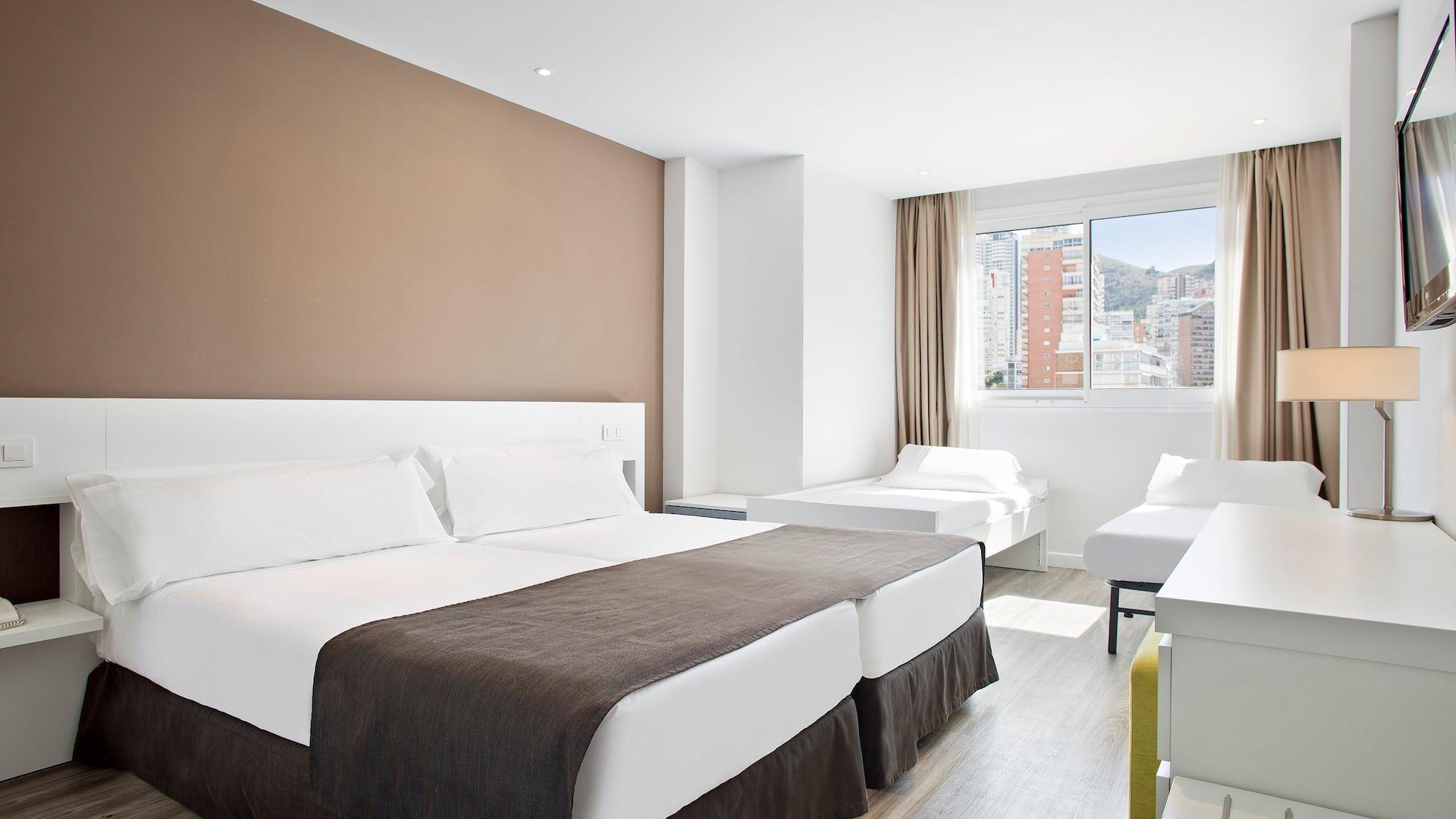 a room with two beds and a window