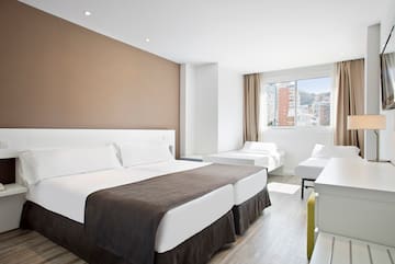 a room with two beds and a window