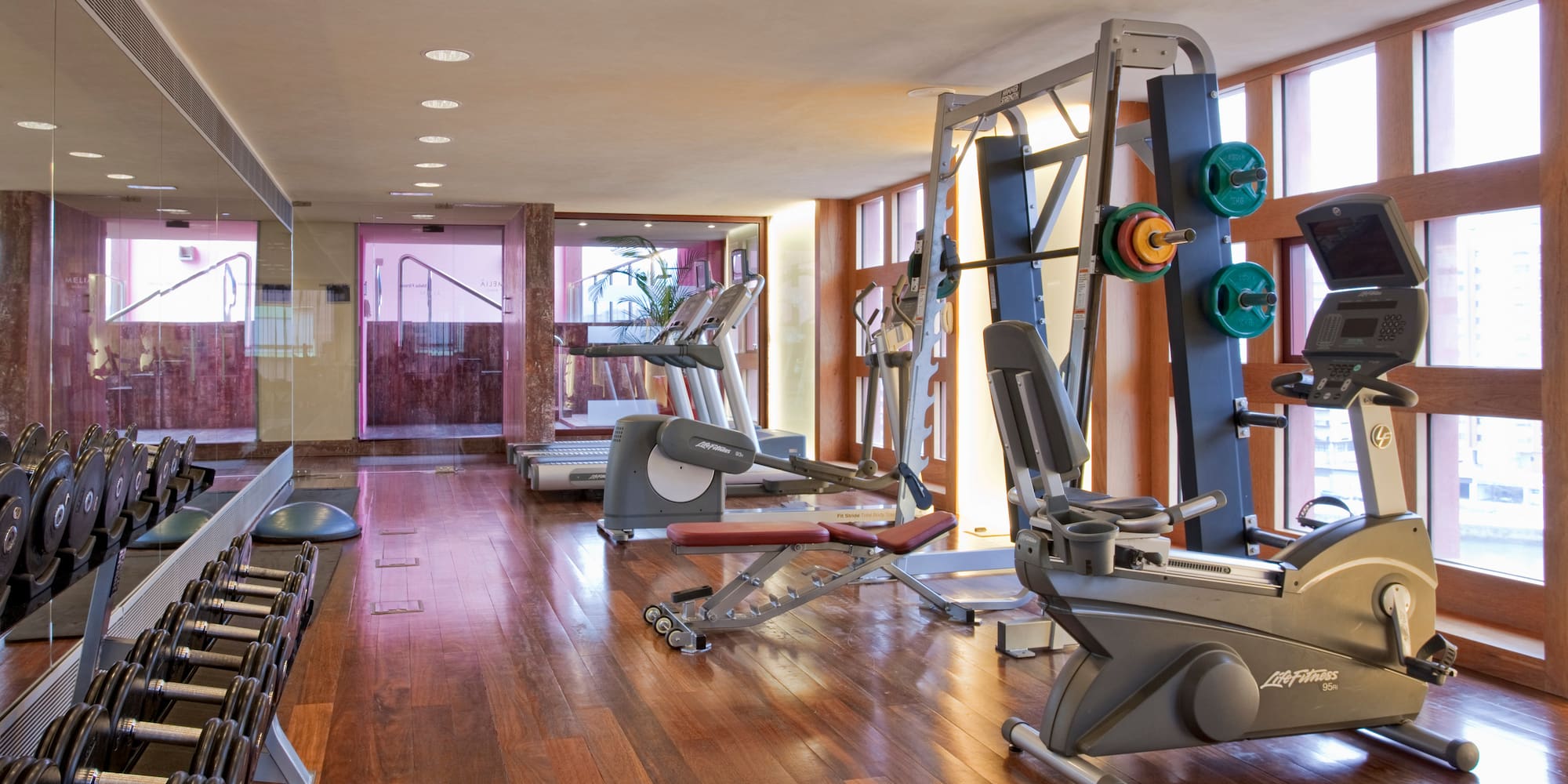 a room with exercise equipment and a large window