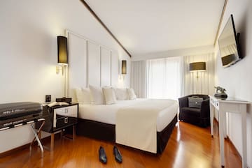 a bedroom with a bed and a pair of shoes