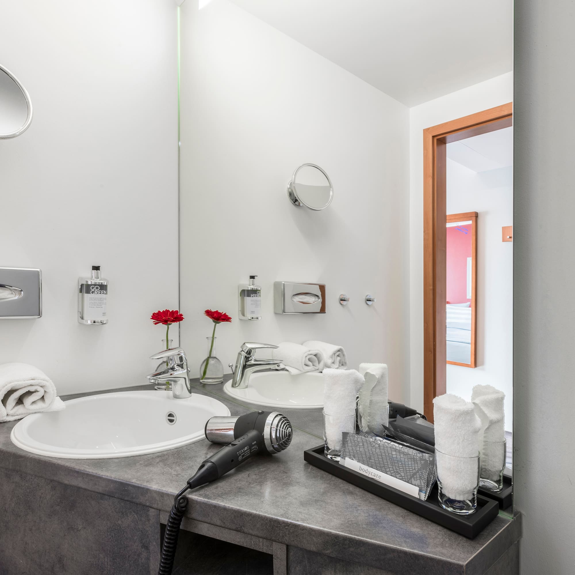 a bathroom with a sink and hair dryer