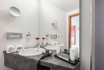 a bathroom with a sink and hair dryer