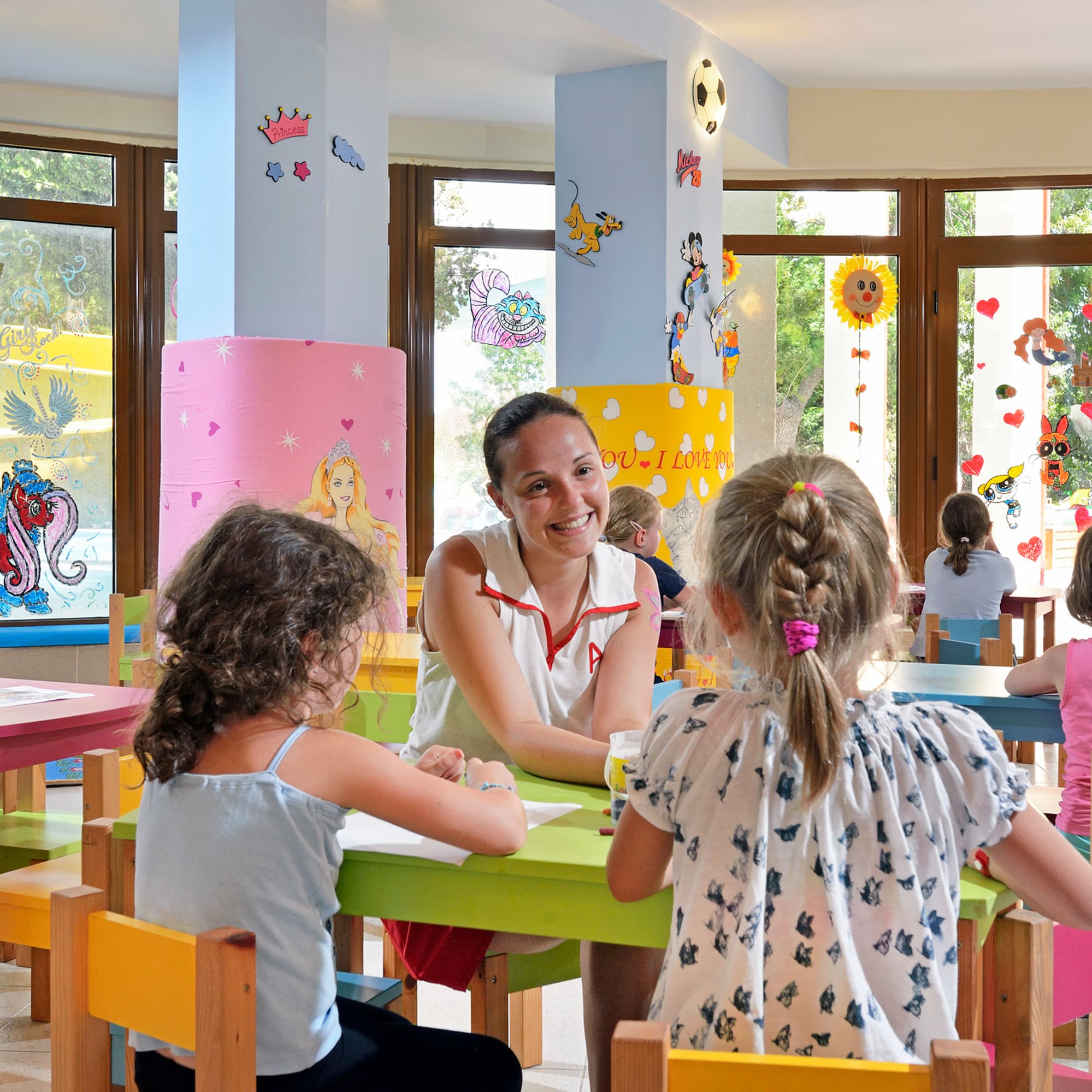 a woman and children sitting at tables