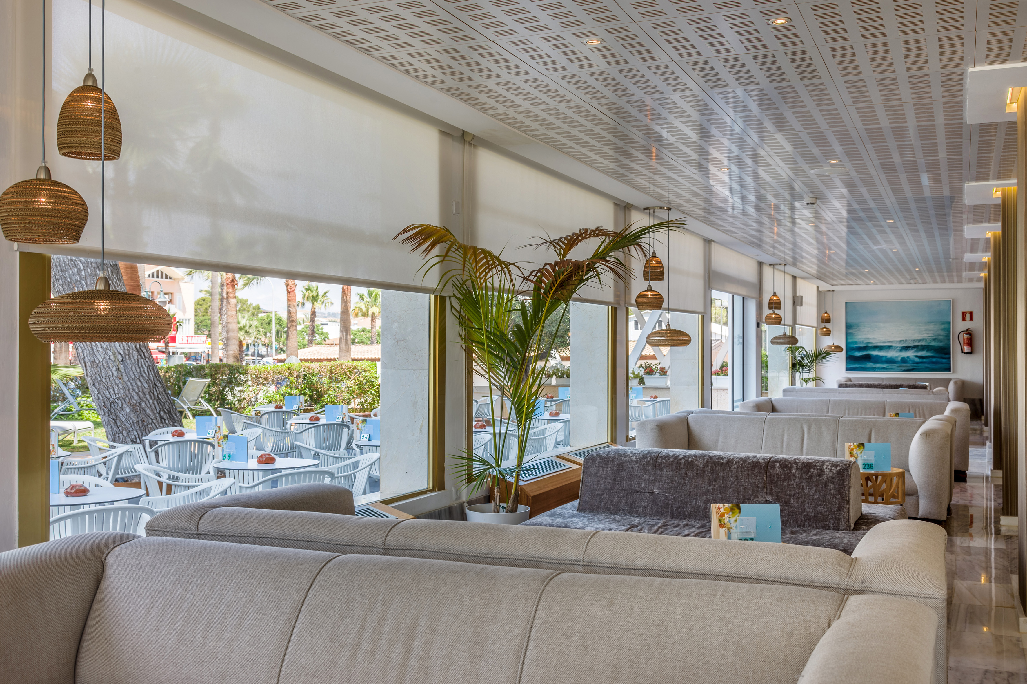 a room with a couch and tables and chairs