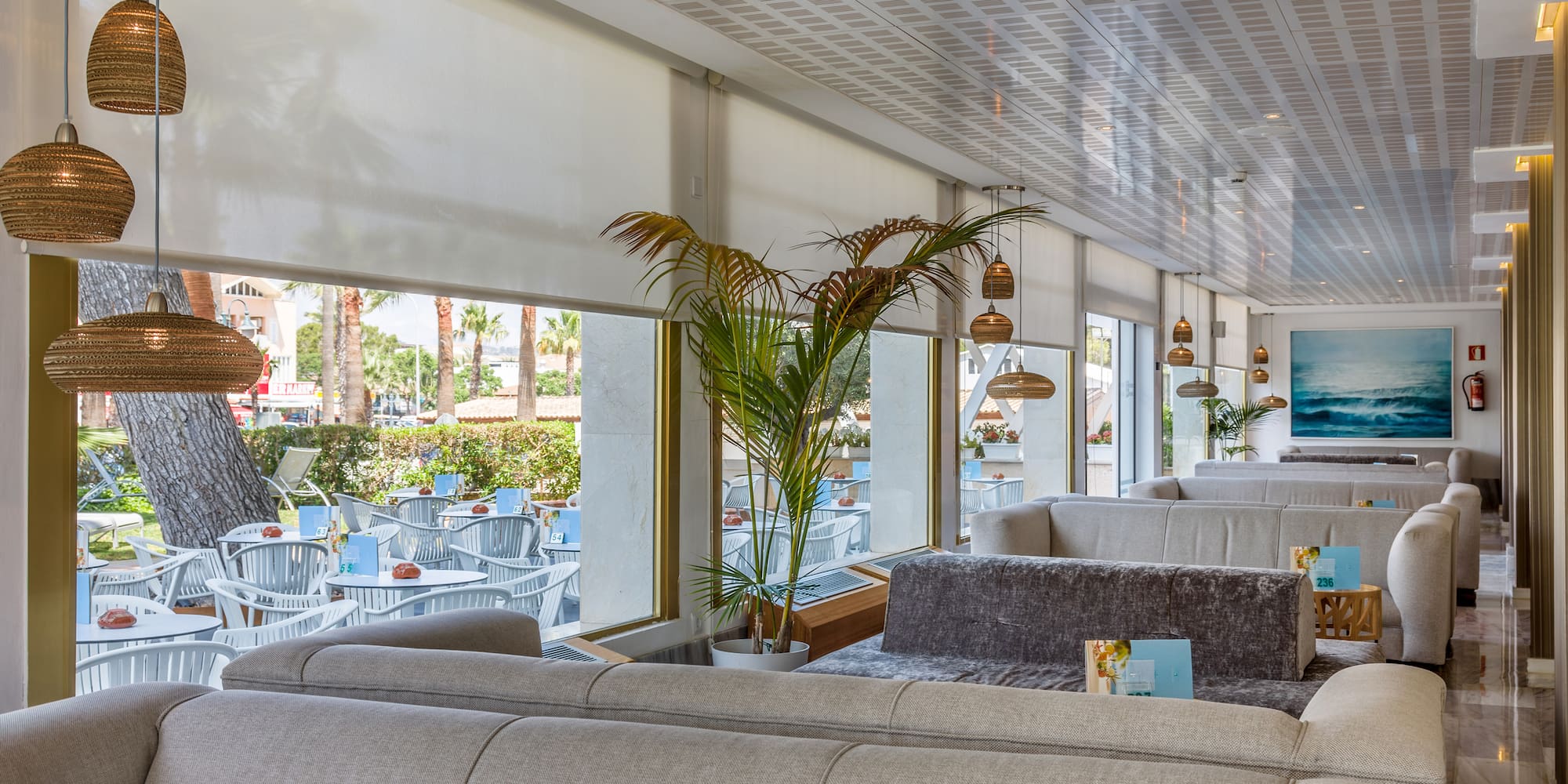 a room with a couch and tables and chairs