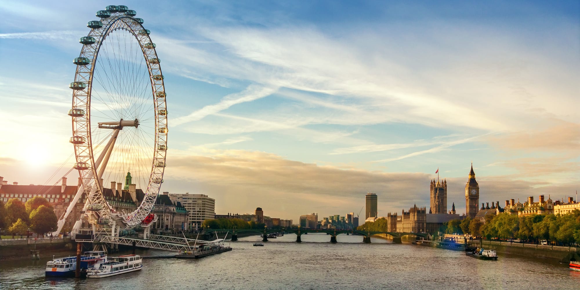 a large ferris wheel next to a river