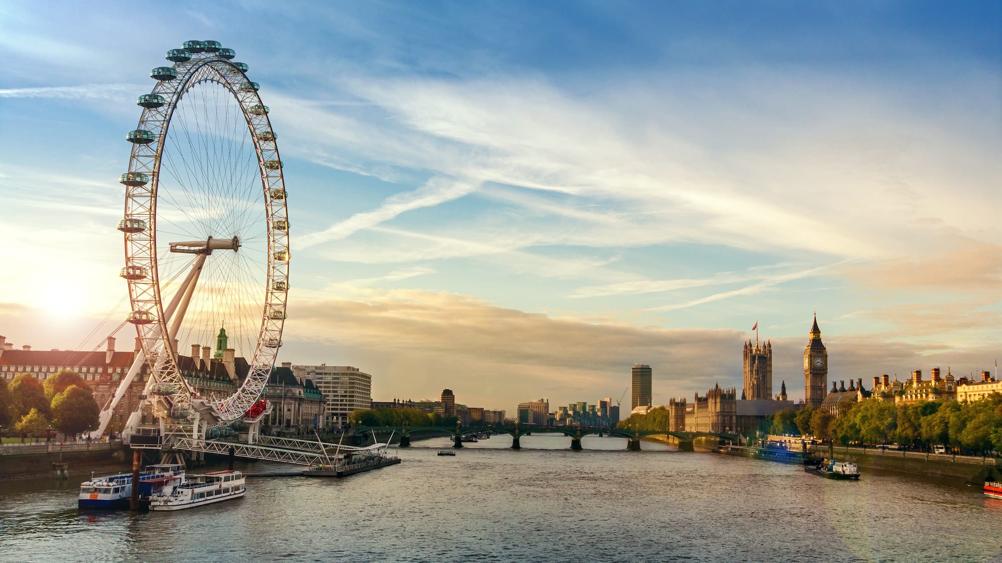 a large ferris wheel next to a river