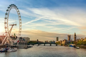 a large ferris wheel next to a river