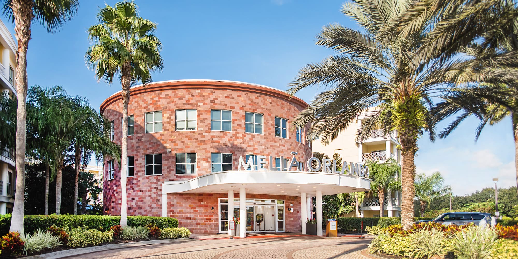 a building with palm trees and a round building