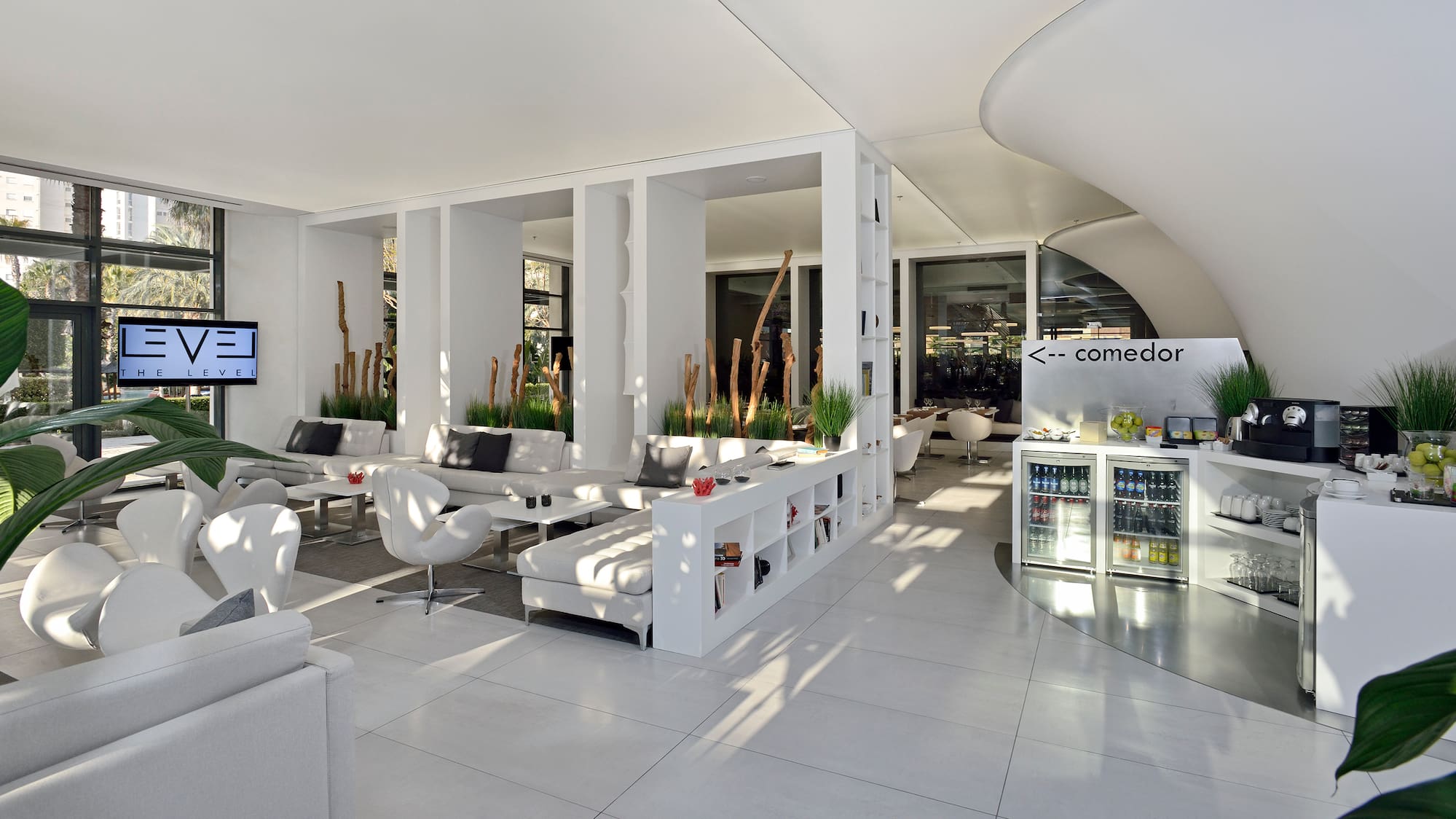 a room with white furniture and a white wall