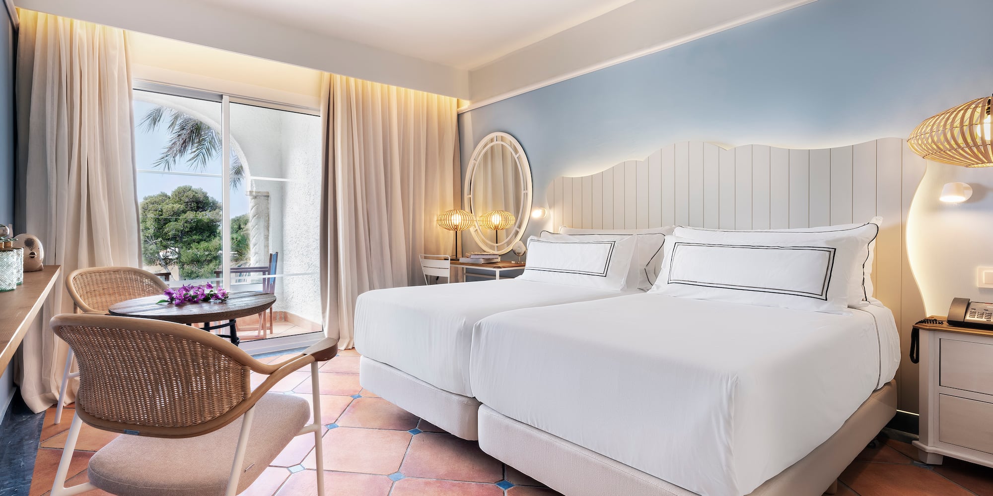 a room with two beds and a chair