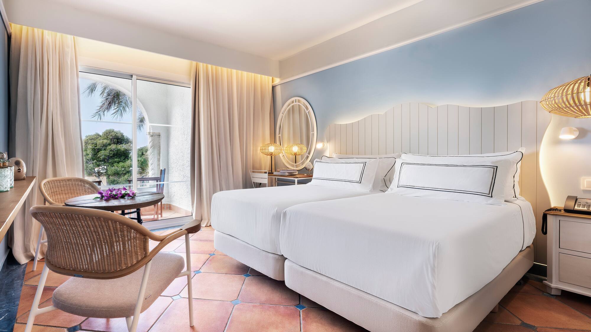 a room with two beds and a chair