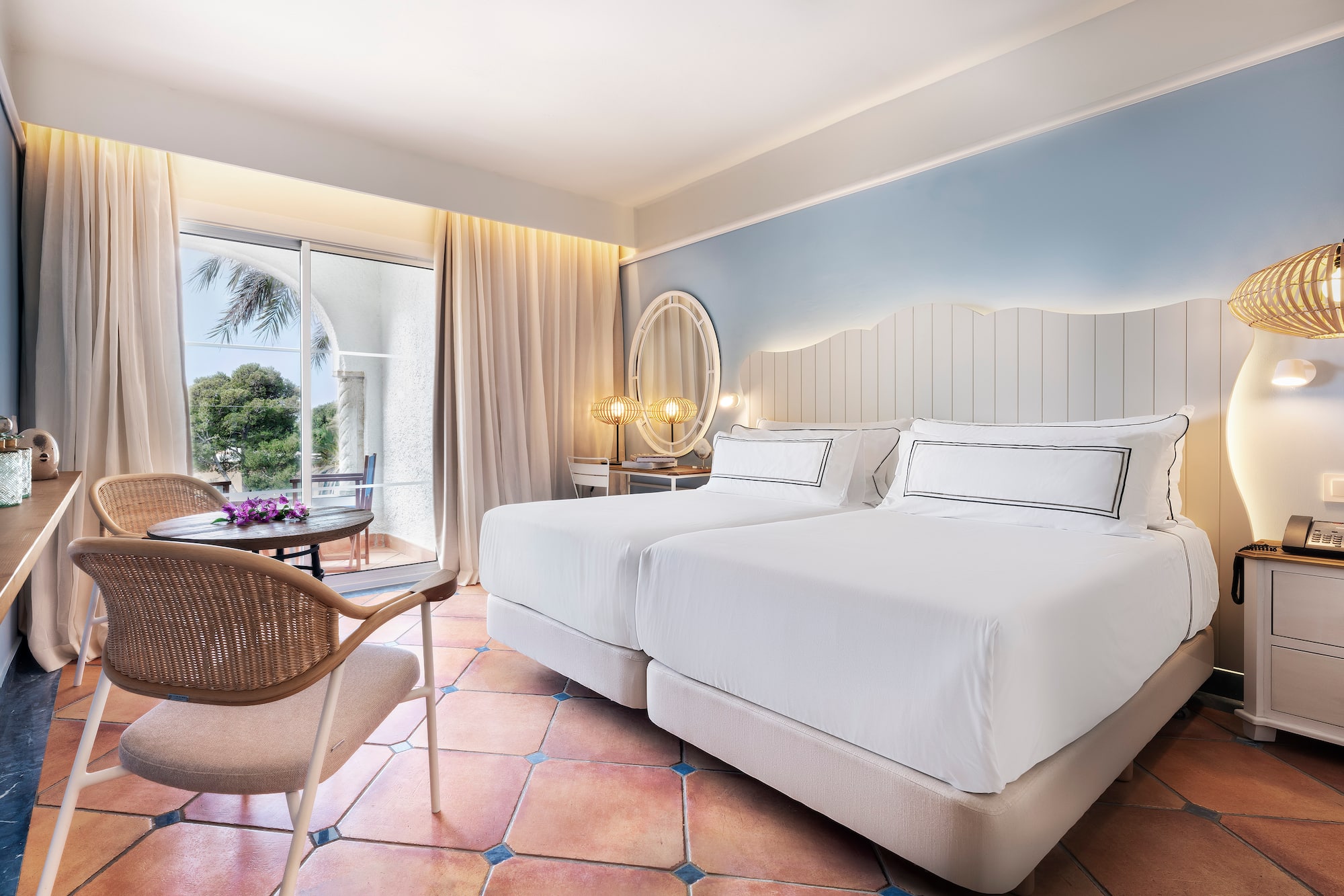 a room with two beds and a chair