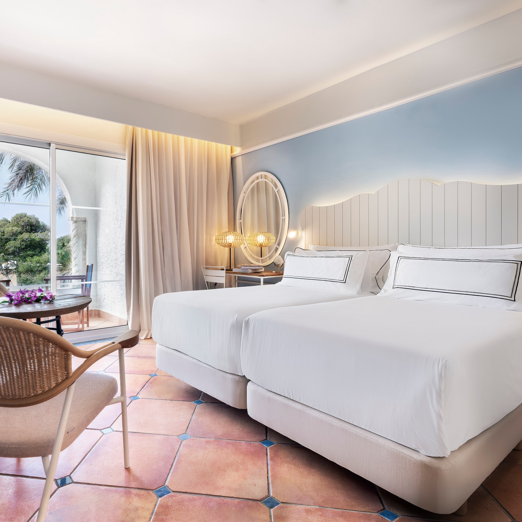 a room with two beds and a chair