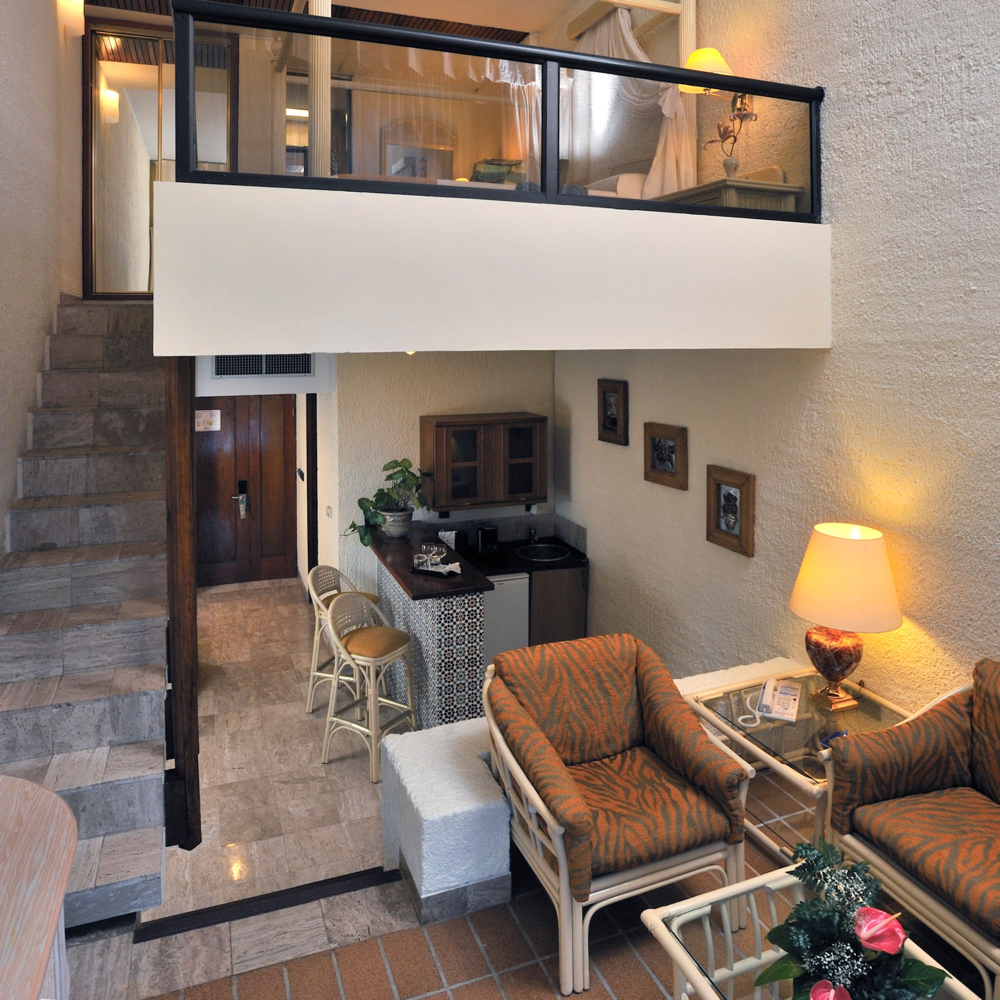 a room with a loft and a couch and chairs