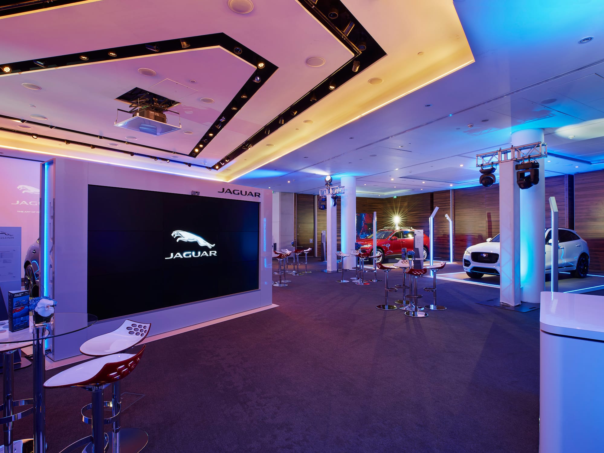 a room with a large screen and chairs