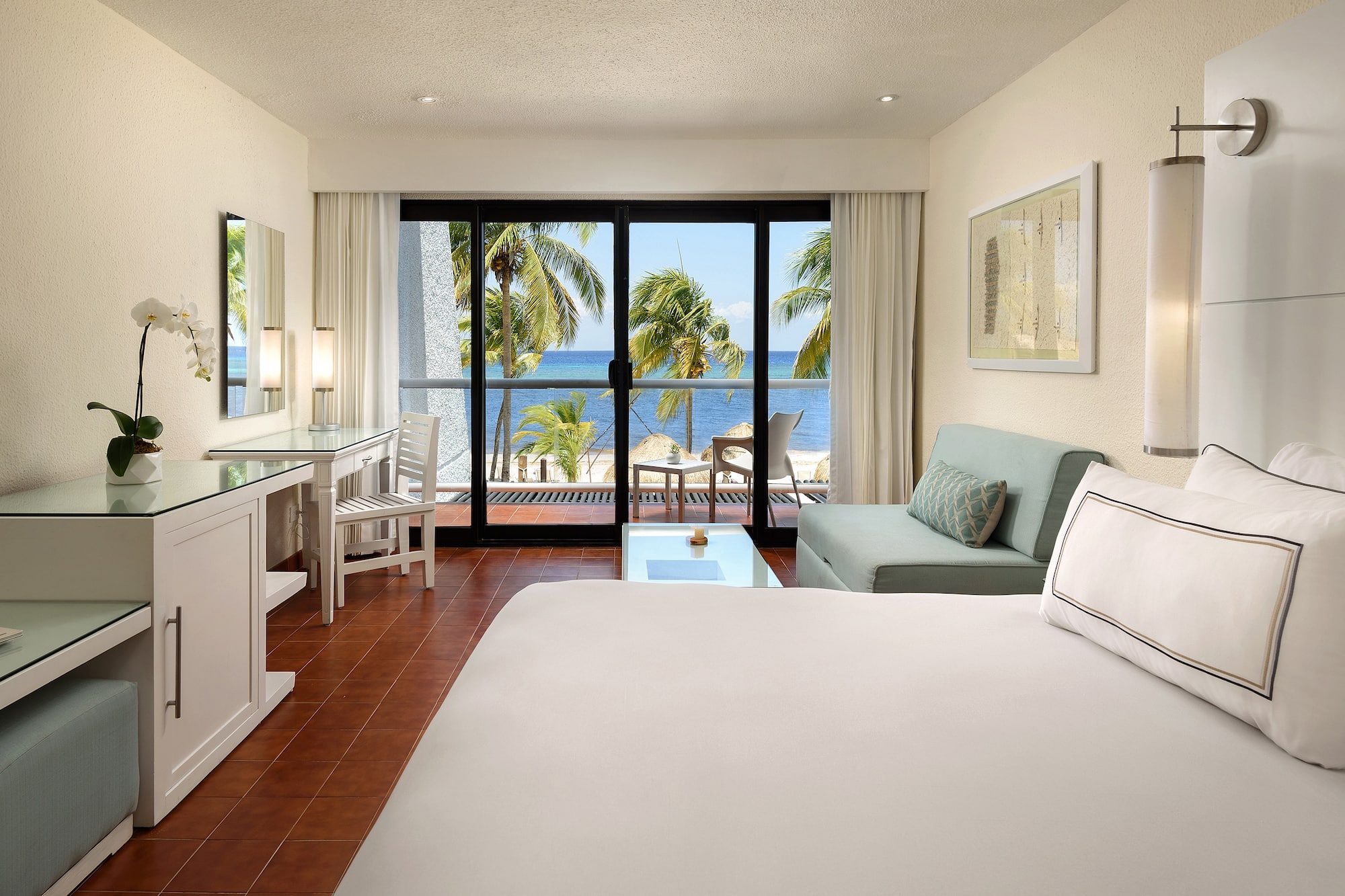 a room with a bed and a table and a mirror