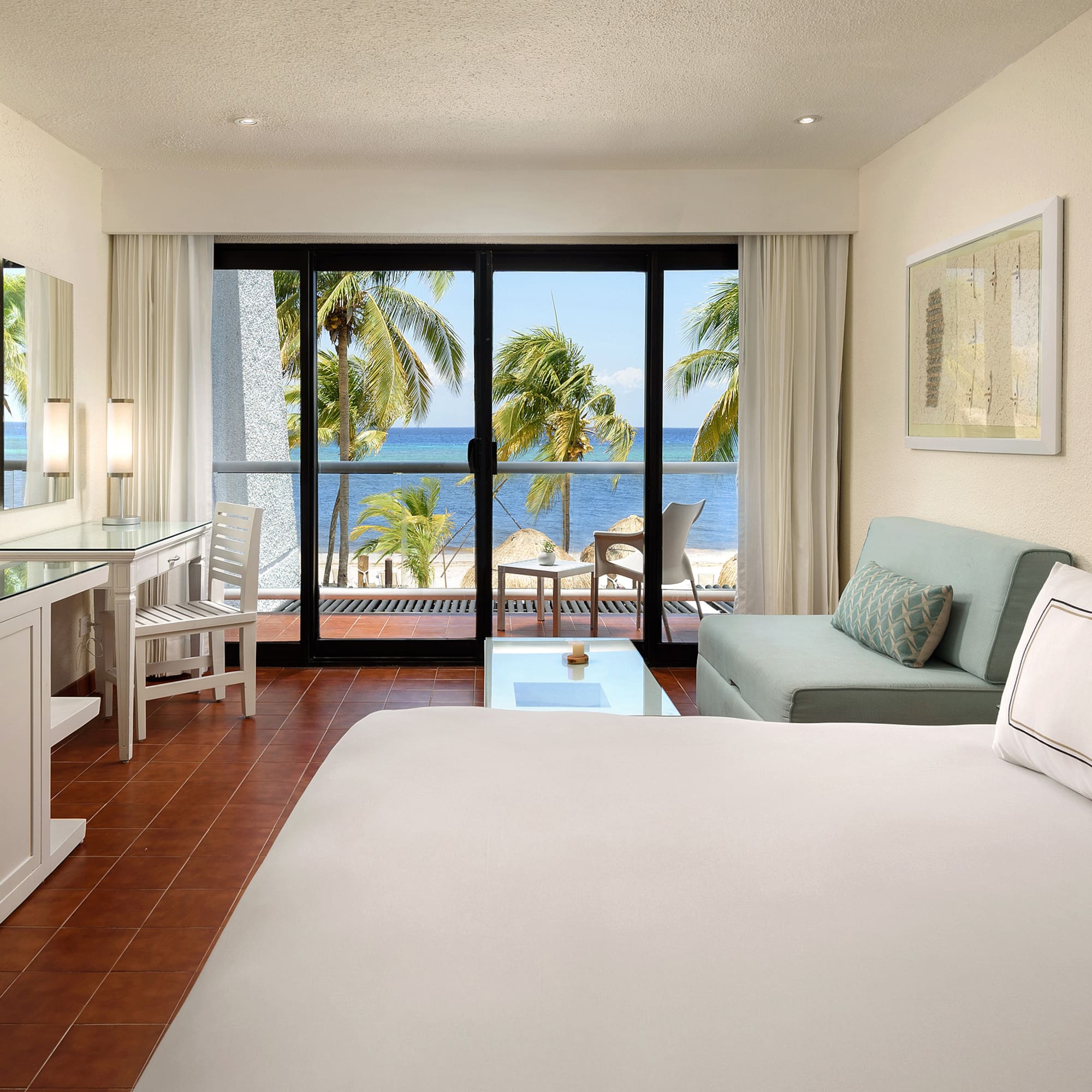 a room with a bed and a table and a mirror