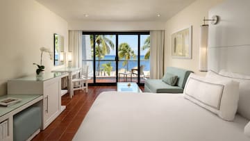 a room with a bed and a table and a mirror