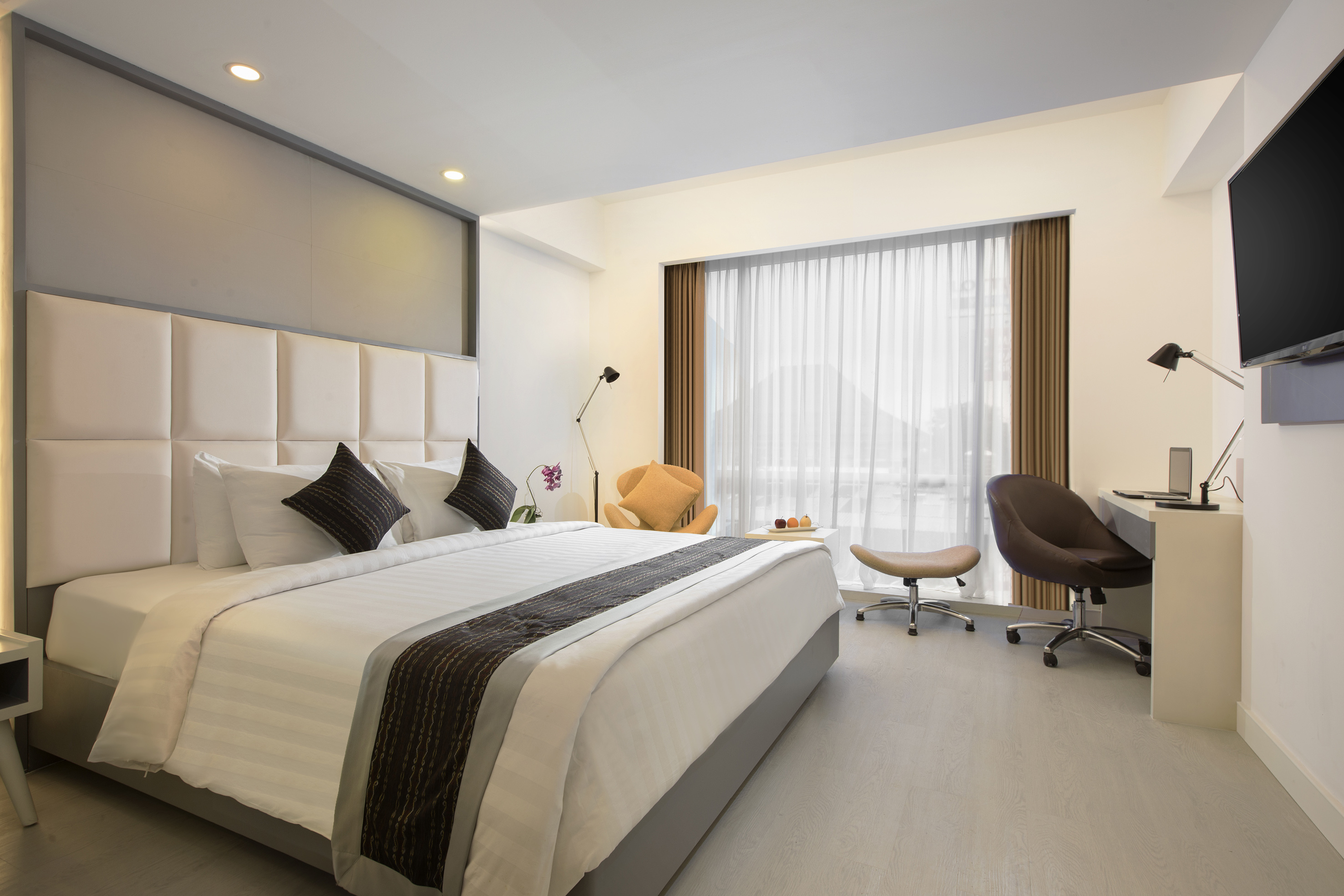 a bedroom with a bed and chair