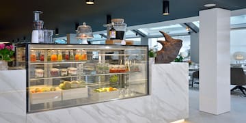 a display case with drinks and a statue of a rhinoceros