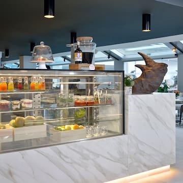 a display case with drinks and a statue of a rhinoceros